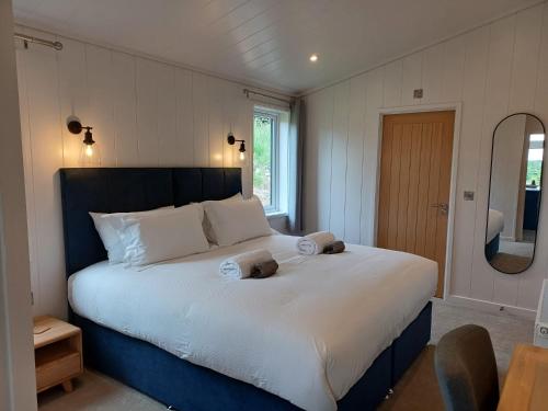 a bedroom with a large bed with towels on it at Falls Park in Ingleton 