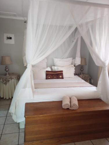 Ένα ή περισσότερα κρεβάτια σε δωμάτιο στο Lilac Lodge