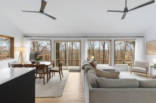 a living room and kitchen with a couch and a table at Dream Retreat with Hot Tub, FirePit, Grill and only 15 min to Downtown Chattanooga in Signal Mountain