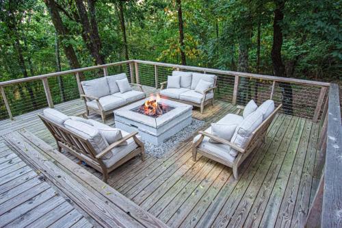 a wooden deck with chairs and a fire pit at Dream Retreat with Hot Tub, FirePit, Grill and only 15 min to Downtown Chattanooga in Signal Mountain
