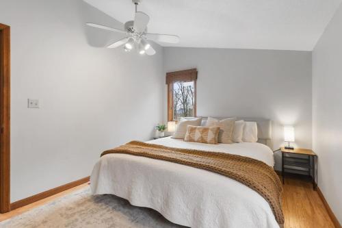 a white bedroom with a bed and a ceiling fan at Dream Retreat with Hot Tub, FirePit, Grill and only 15 min to Downtown Chattanooga in Signal Mountain