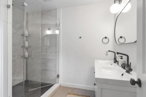 a white bathroom with a sink and a shower at Dream Retreat with Hot Tub, FirePit, Grill and only 15 min to Downtown Chattanooga in Signal Mountain