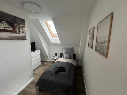 a small bedroom with a bed in a attic at ElasFerienhaus in Marne