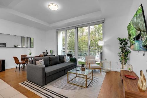 a living room with a couch and a table at 1BR Near BOK Center-Gym, Lounge, Balcony, Pets OK in Tulsa