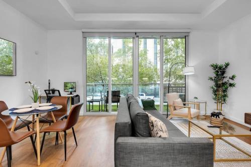a living room with a couch and a table at 1BR Near BOK Center-Gym, Lounge, Balcony, Pets OK in Tulsa