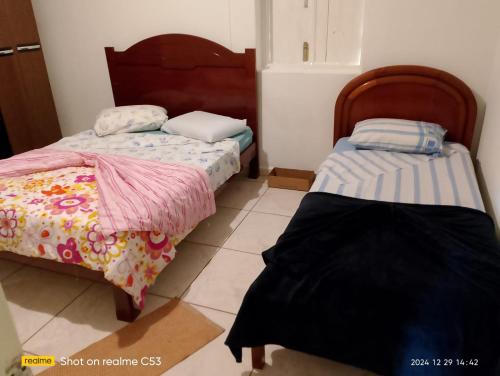 two beds sitting next to each other in a room at Pousada Sossego in São José da Barra