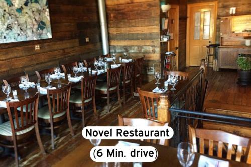 a restaurant with tables and chairs in a room at Classy 2BR-Parking, Rooftop,Near Arrowhd & TMobile in Kansas City