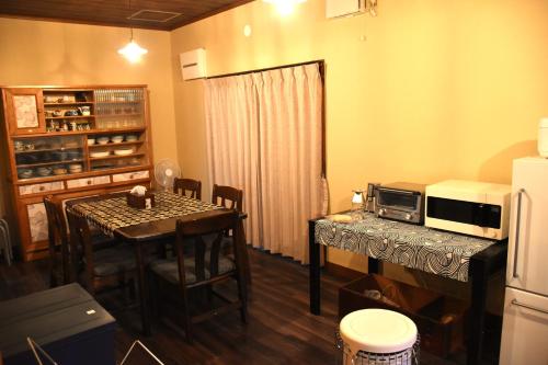 a small kitchen with a table and a microwave at Traditional Japanese House -Near Matsumoto Castle- in Matsumoto