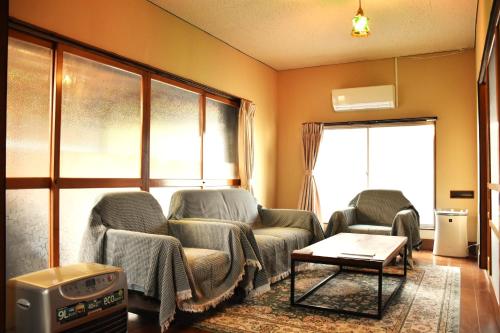 a living room with two chairs and a tv at Traditional Japanese House -Near Matsumoto Castle- in Matsumoto