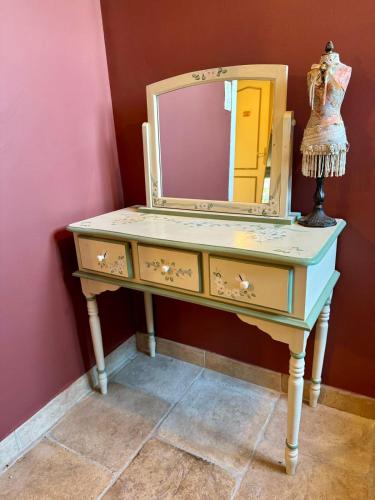 a dressing table with a mirror on top of it at Charmante maison provençale in Les Taillades