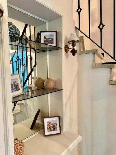 a room with a mirror and some pictures on a shelf at Charmante maison provençale in Les Taillades