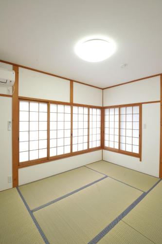 an empty room with large windows and a large room with a large room at HAT Sanjo M 7min walk from JR Nara St in Nara