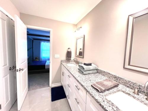 a bathroom with a sink and a mirror at Rest Easy in North Carolina in Denver