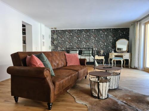 a living room with a brown couch and a table at Haus Alpenblick in See