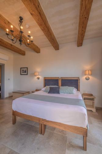 a bedroom with a large bed with wooden ceilings at Mulberries in Żabbar