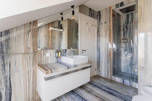 a bathroom with a sink and a shower at Chiado Square Apartments | Lisbon Best Apartments in Lisbon