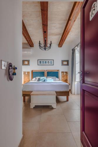 a bedroom with a bed and a wooden ceiling at Mulberries in Żabbar