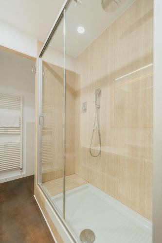 a shower with a glass door in a bathroom at Residence Degli Aranci - Casêta in Ancona