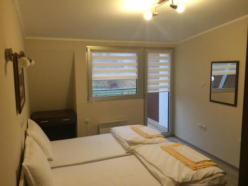 a bedroom with two beds and a window at Prenociste Gazela in Pirot