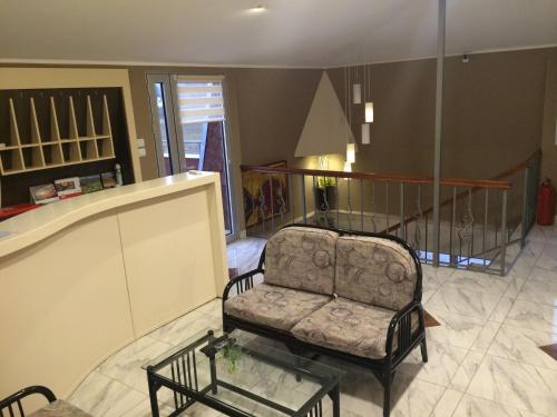 a living room with a chair and a glass table at Prenociste Gazela in Pirot