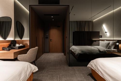 a hotel room with two beds and a mirror at Garni Hotel Galeria in Banja Luka