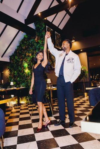 a man and a woman standing on a dance floor holding their hands up at The Chesterton Hotel in Bicester