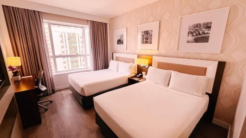Ένα ή περισσότερα κρεβάτια σε δωμάτιο στο Holiday Inn Belo Horizonte Savassi by IHG