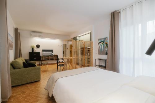 a bedroom with a bed and a living room at Residence Degli Aranci - Casêta in Ancona