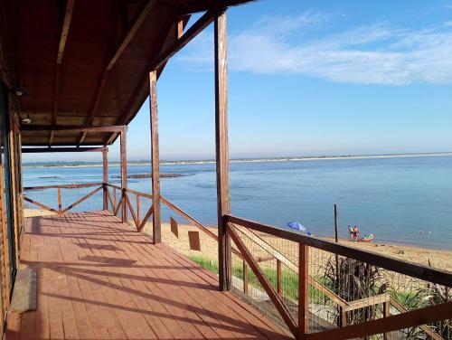a view of the beach from the porch of a house at El Parador in Paso de la Patria