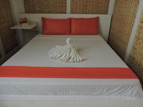 a bedroom with a bed with a swan on it at Orange Mangrove Pension House by SMS Hospitality in Puerto Princesa City