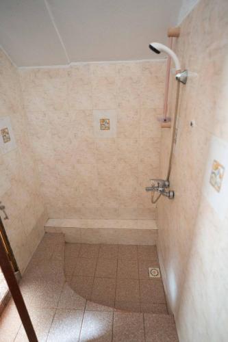 a bathroom with a shower with a tub at Private Villa & Pool, steps from the Beach in Flic-en-Flac