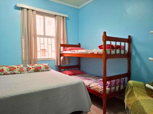 a bedroom with two bunk beds and a window at Caeté in Torres