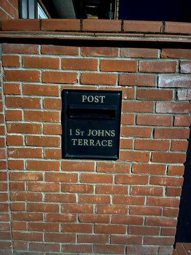 a sign on the side of a brick wall at 2 bedroom Hidden Gem in Stamford with parking in Stamford