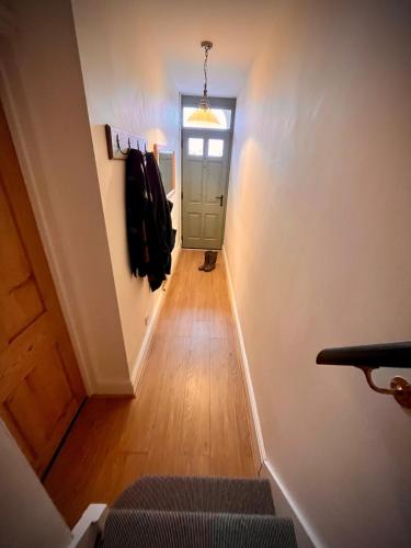 a hallway with a stairway with a door and a hallwayngth at 2 bedroom Hidden Gem in Stamford with parking in Stamford