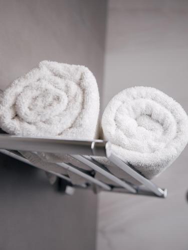 a pair of towels on a towel rack at MIRAMAR Apart Hotel & SPA in Aktau