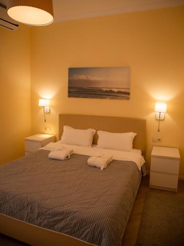 a bedroom with a large bed with two night stands at MIRAMAR Apart Hotel & SPA in Aktau