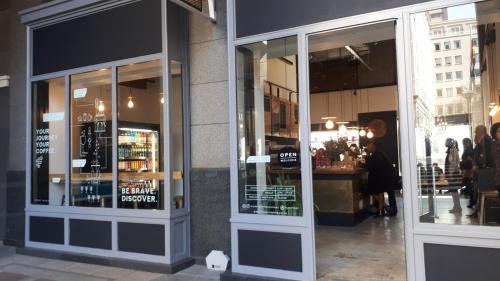 a store window of a store with people walking outside at The Franklin Luxury Condo with UPS for Wi-Fi in Johannesburg
