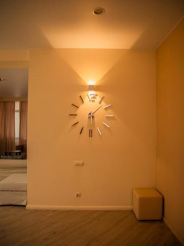 a clock on a wall in a room at MIRAMAR Apart Hotel & SPA in Aktau
