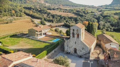 an aerial view of a house with a church at Els Majordoms - El Mont in Beuda
