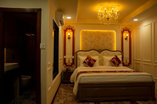 a bedroom with a bed and a chandelier at G Ramayana in Kathmandu