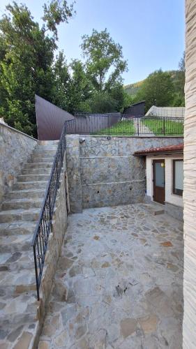 a stone staircase leading up to a building with a stair railing at Casa Zânelor Slănic Moldova in Slănic-Moldova