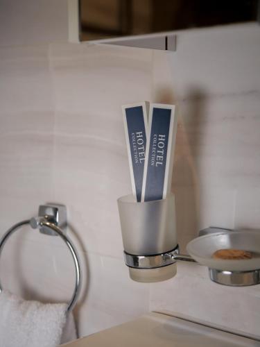 a kitchen counter with a cup with utensils in it at MIRAMAR Apart Hotel & SPA in Aktau