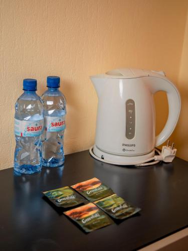 a toaster and two bottles of water on a counter at MIRAMAR Apart Hotel & SPA in Aktau