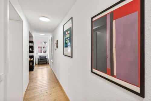 a hallway with paintings on the walls at Residenz im historischen Zentrum - Aalen Apartments & Suites in Aalen