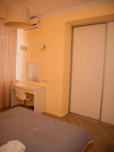 a bedroom with a desk and a bed and a desk at MIRAMAR Apart Hotel & SPA in Aktau