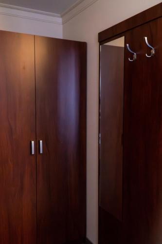 a room with two wooden cabinets and a mirror at Nad Borkiem in Kosarzyn