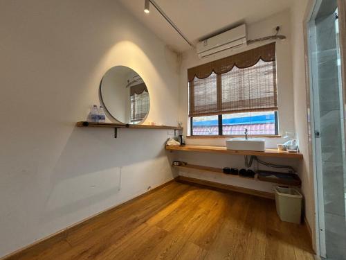 a bathroom with a sink and a mirror at Junshe Youth Hostel in Guilin