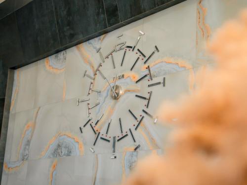 a clock on the side of a wall at MIRAMAR Apart Hotel & SPA in Aktau