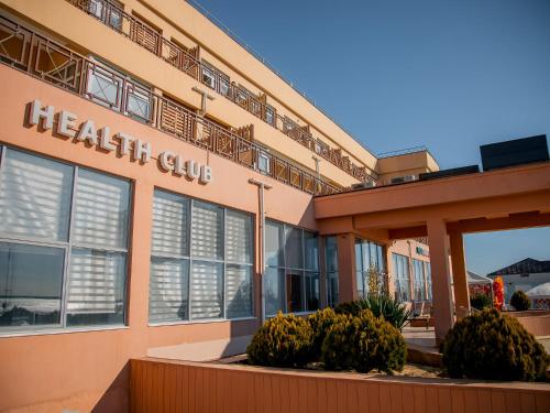 a hospital building with a health club sign on it at MIRAMAR Apart Hotel & SPA in Aktau