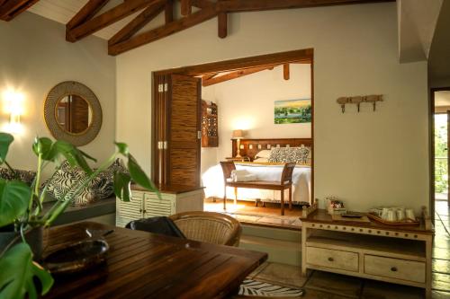 a room with a bedroom with a bed and a table at Broadwater River Estate in Douglas